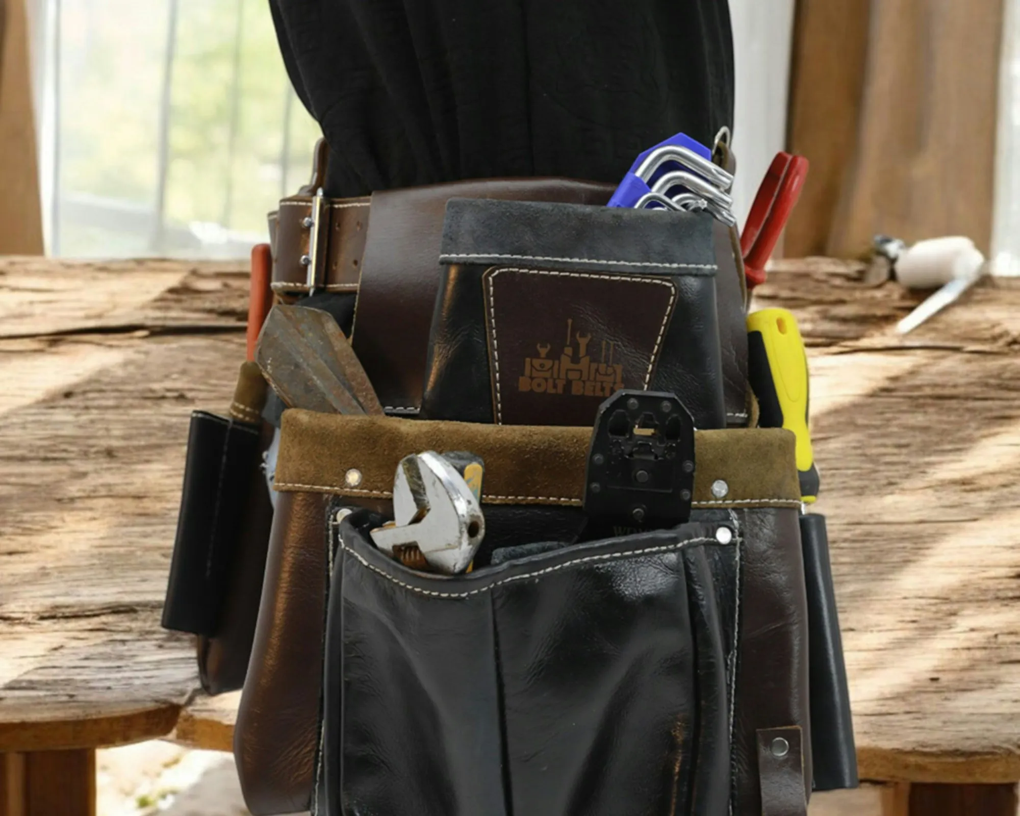 Electrician tool belt resting on a workbench