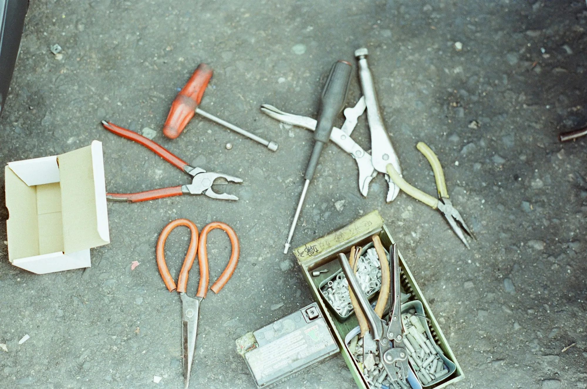 Hand tools laid out on a concrete floor